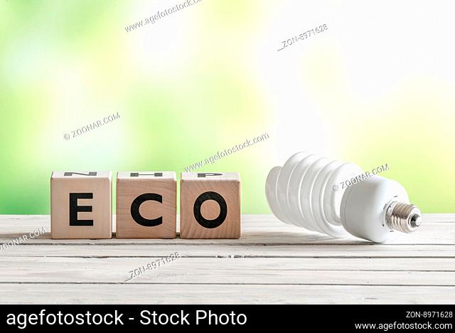 Big eco bulp on a wooden table on green background