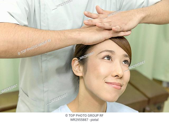 Doctor Manipulating the Head of A Woman