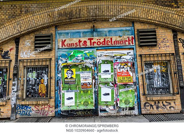 with posters and graffiti spotted house wall in the center of Berlin