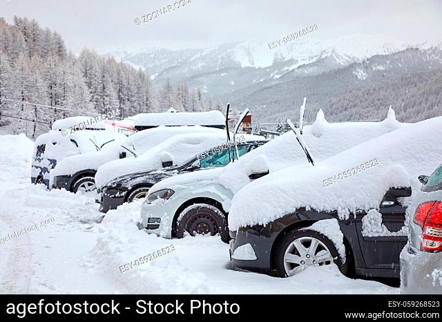 Parking cars covered by a lot of snow