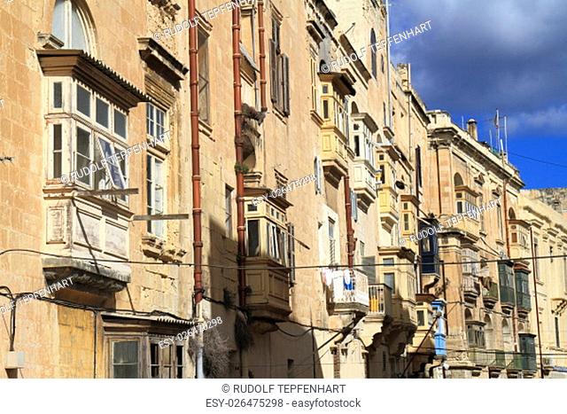 Street with colorful balconies in historical part of Valletta, Malta