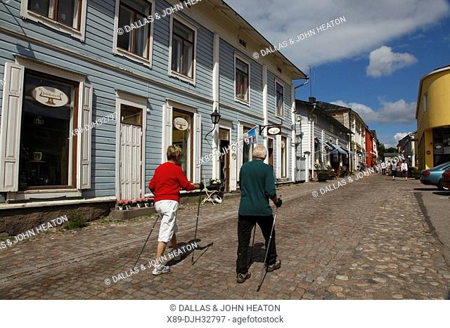 Finland, Southern Finland, Eastern Uusimaa, Porvoo, Medieval Wooden Houses, Shopping Street, Couple Pole Walking