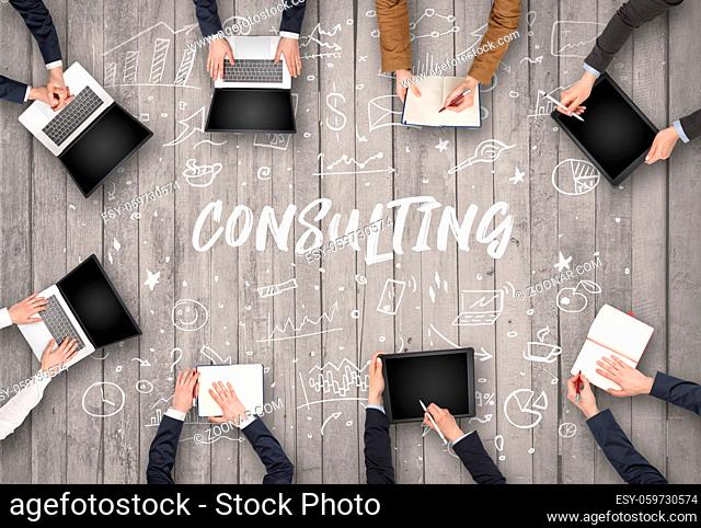 Group of business people working in office with CONSULTING inscription, coworking concept