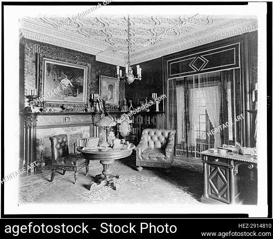 Room with plasterwork ceiling, fireplace, and circular table., Greenwich, Connecticut, 1908. Creator: Frances Benjamin Johnston