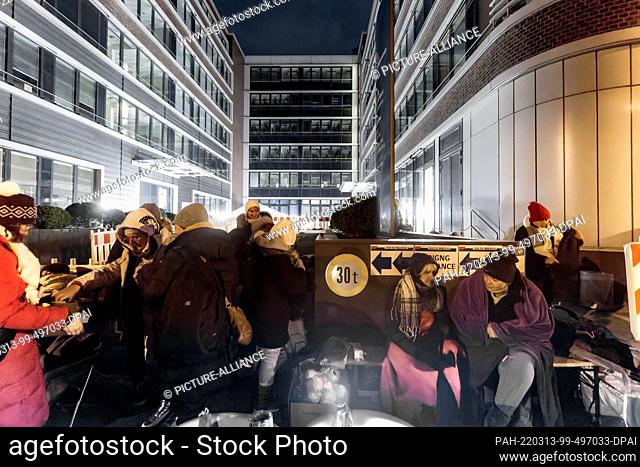 12 March 2022, Hamburg: Refugees from Ukraine wait in front of the Hammer Straße registration office. They hold out overnight on site in order not to lose their...