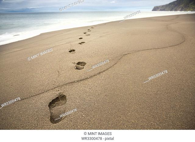 Close up of footprints in beach sand