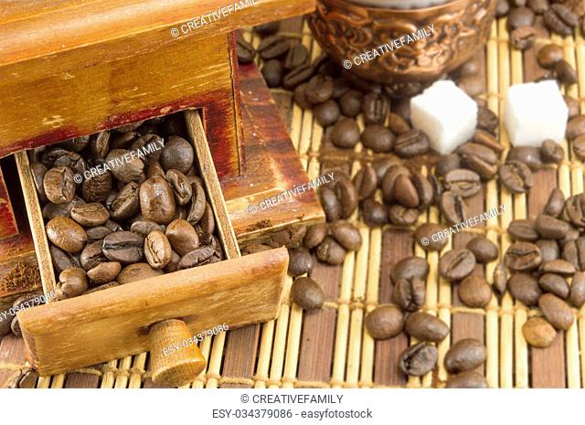 Coffee time. Coffee beans in all grinder drawer with coffee beans spread arround