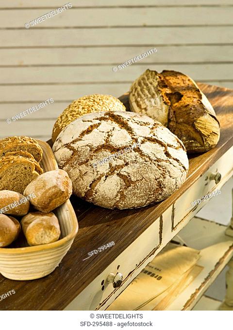 Various types of organic bread on a wooden surface