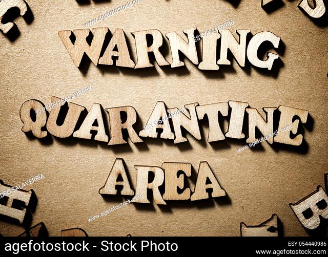 Warning Quarantine Area sentence on a brown paper