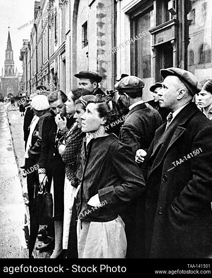 Moscow, USSR. Local people stand in front of the speaker on the 25th October Street and listen to the radio message about the attack of Nazi Germany on the...