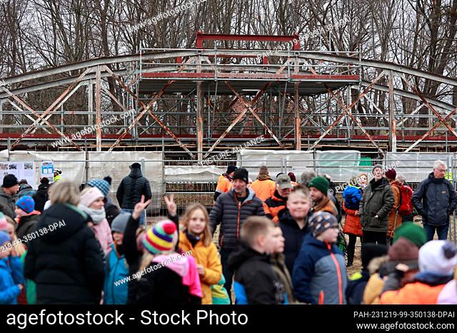 19 December 2023, Saxony-Anhalt, Weddersleben: Onlookers watch the relocation of the Peace Bridge near Weddersleben. The 50-ton Peace Bridge was moved across...