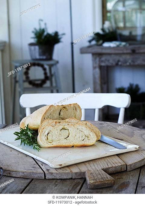 Yeast bread with rosemary on a rustic wooden table