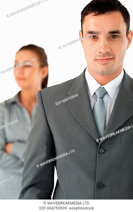 Close up of confident businessman with colleague behind him