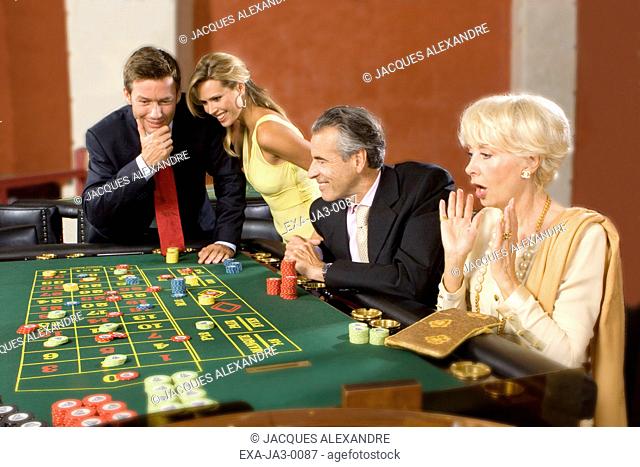 Senior couple and young couple at roulette table