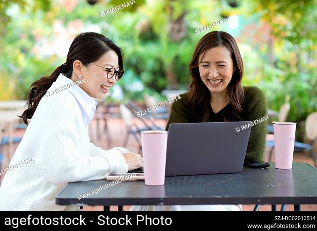 Two women having meeting in open space office
