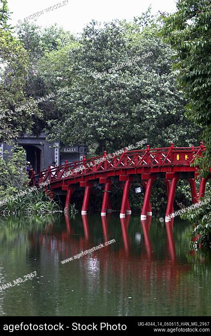The red Huc Bridge reflected in in Hoan Kiem Lake leads to Ngoc Son island Jade Mountain Confucian temple Hanoi Vietnam