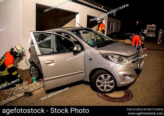 22 August 2021, Lake Constance District, Gärtringen: A car is parked at a damaged garage entrance. A senior citizen drove her car into a garage door and a house...