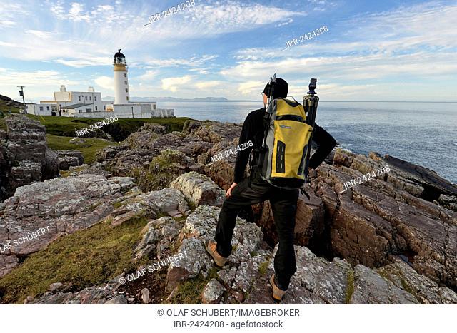 Hiker with a backpack in front of Rua Reidh Lighthouse, Melvaig, Gairloch, Western Ross, Scotland, United Kingdom, Europe