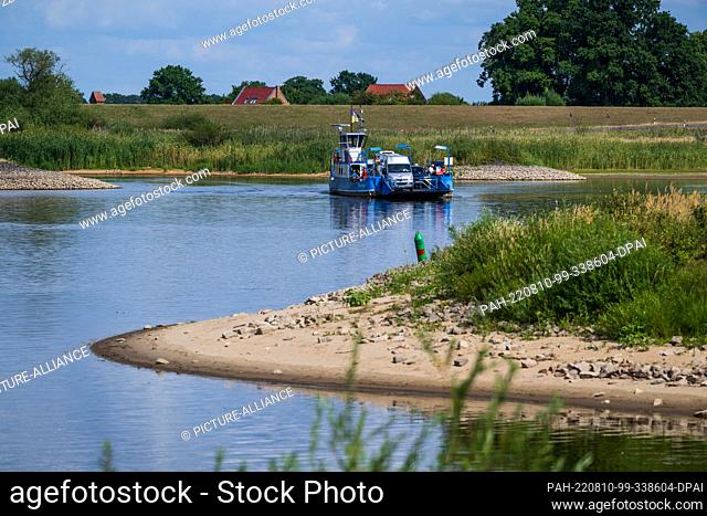 09 August 2022, Lower Saxony, Bleckede: The Elbe ferry ""Amt Neuhaus"" crosses the Elbe at low water. It has hardly rained for weeks and the water levels of the...