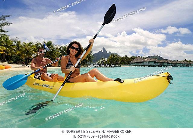 Tourist couple in a kayak, St. Regis Bora Bora Resort, Bora Bora, Leeward Islands, Society Islands, French Polynesia, Pacific Ocean