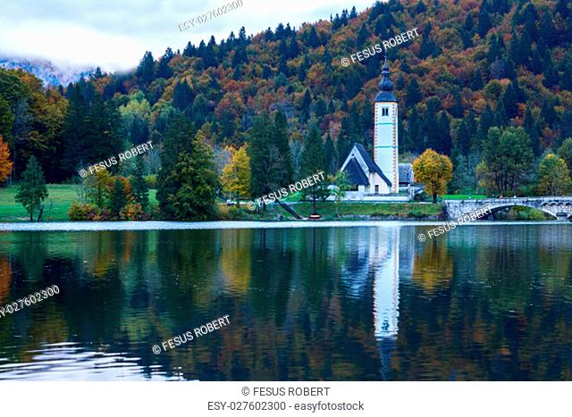 Church tower and stone bridge at Lake Bohinj in alpine village Ribicev Laz, Slovenia