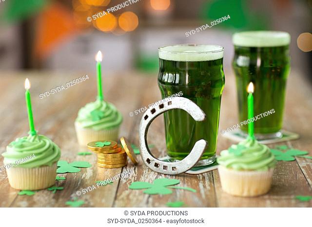 glasses of beer, cupcakes, horseshoe and coins