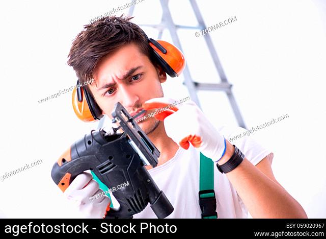 Young worker with earmuffs in noise cancelling concept