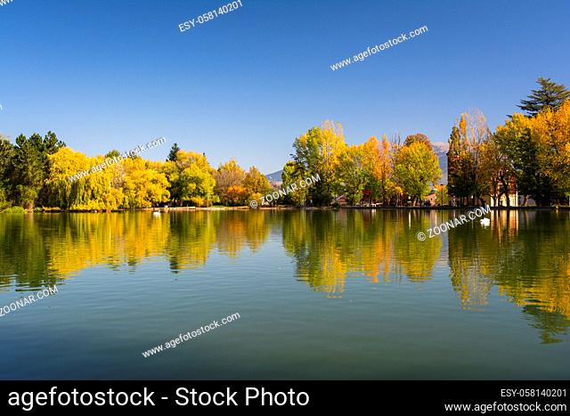 Autumn colors and reflection on Puigcerda's pond in Pyrenees. Located in north Catalonia, Spain