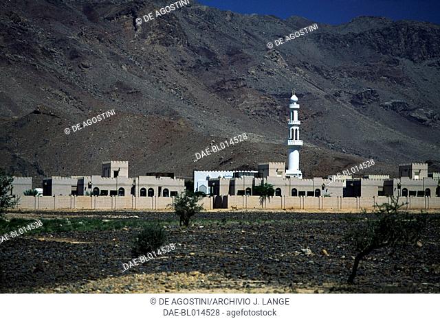 Village in the Wadi Samail, in the background the Al-Hajar Mountains, Oman
