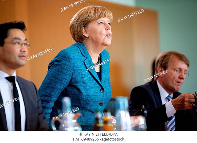 German chancellor Angela Merkel opens the cabinet meeting next to Economy Minister Philipp Roesler (L) and chancellery chief of staff Ronald Pofalla at the...