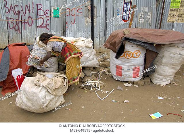 an homeless poor woman collect papaer from street rubbish. sakinaka district. mumbay. maharashtra. india. asia