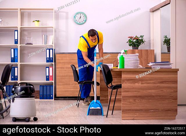 Male contractor cleaning the office