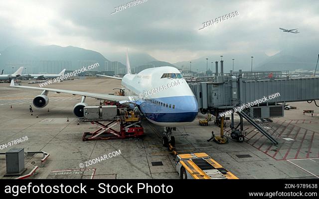 Loading cargo containers into the airplane with airbridge in Hong Kong airport