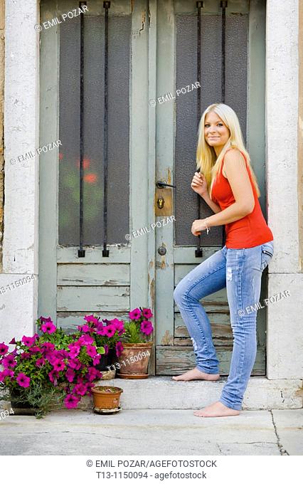 Entering a traditional old-fashioned European house young woman