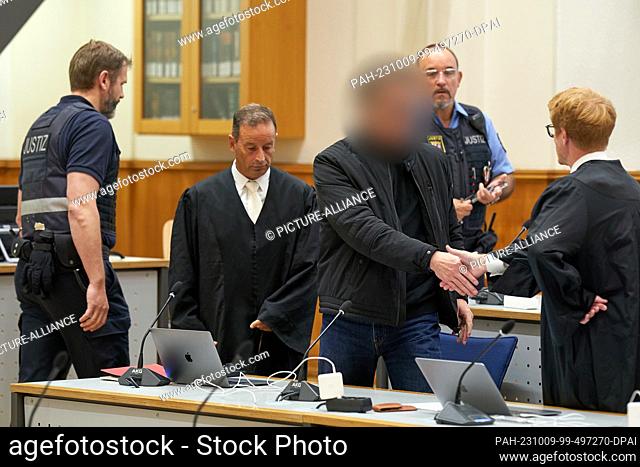 09 October 2023, Rhineland-Palatinate, Koblenz: The defendant (M) is led into the courtroom of the Higher Regional Court for the announcement of the verdict