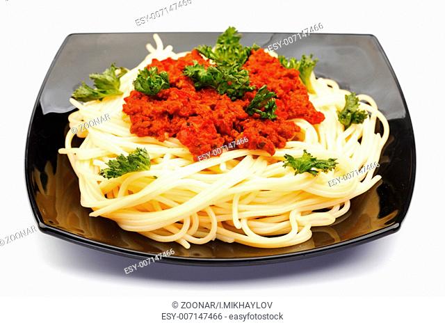 Spaghetti bolognese on black plate