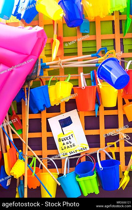 Bucket and spades and other beach items for sale, holiday resort, England