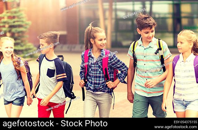 group of happy elementary school students walking