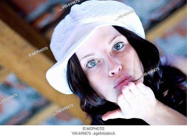 cute dark-haired woman with fashinable cap, doing an air kiss  - 07/02/2008