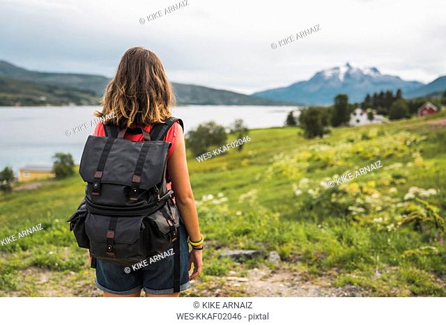 Young woman with a backpack traveling Norwegian Lapland