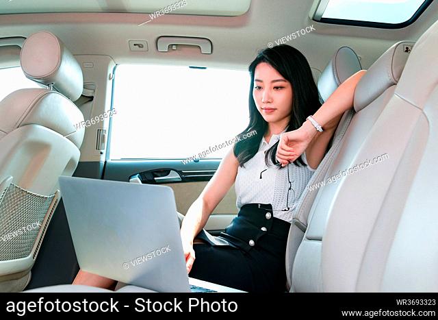 Using laptop business women in the car
