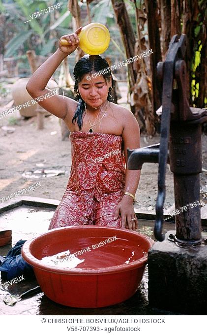 YOUNG WOMAN BATHING, SRAS SANG VILLAGE, ANGKOR, CAMBODIA