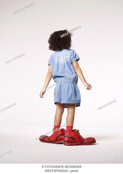 Girl in large clown shoes
