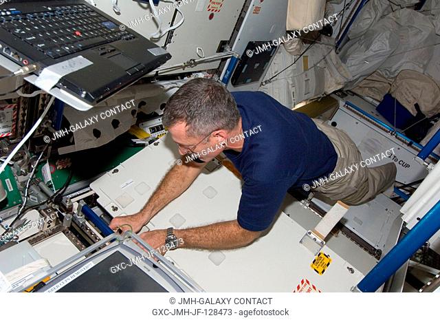 NASA astronaut Dan Burbank, Expedition 29 flight engineer, works with the Urine Processor Assembly (UPA) in the Tranquility node of the International Space...