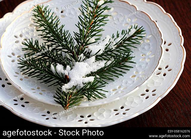 Festive Christmas table setting, table decoration with fir branches, woodene background