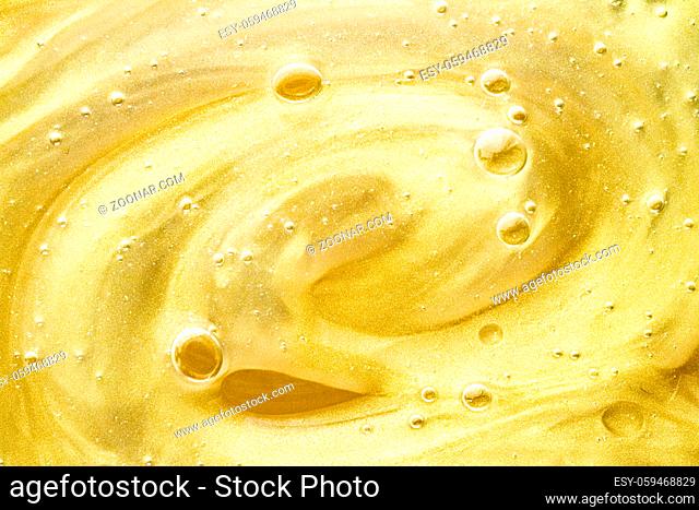 Abstract golden liquid background, paint splash, swirl pattern and water drops, beauty gel and cosmetic texture, contemporary magic art and science as luxury...