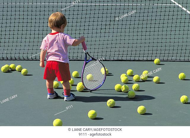 Young child holding tennis racquet