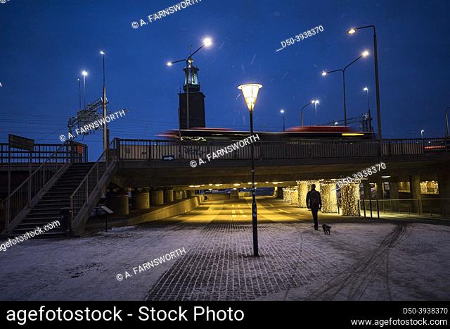 Stockholm, Sweden A person walks in the early morning in the snow on Klara Malarstrand
