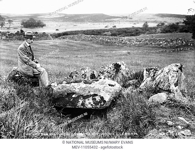 Chamber in Kistvaen Gowerstown, Above Glenarm - a view of a stone Dolmen with the photographer sitting to the left. (Location: Northern Ireland: County Antrim:...