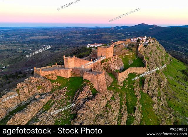 Marvao drone aerial view of the historic village and Serra de Sao Mamede mountain at sunset, in Portugal